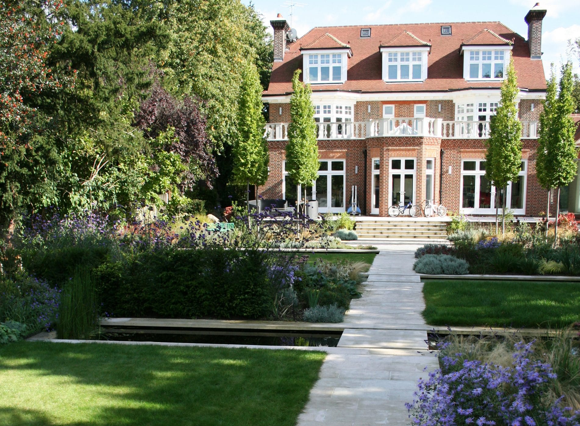 A view towards the house showing the 3 canals in the arts and crafts garden