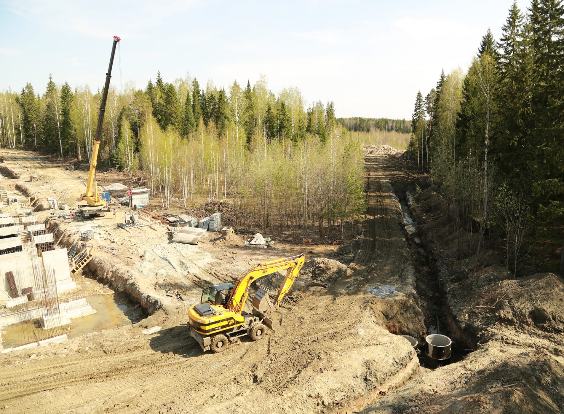 The construction site of the European Village development building around the woodland trees