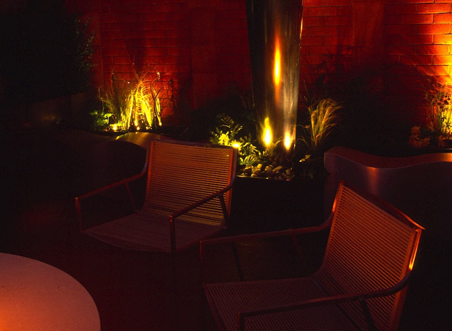 Knightsbridge Roof Terrace at night with lighting highlighting the plants and providing a feeling of warmth