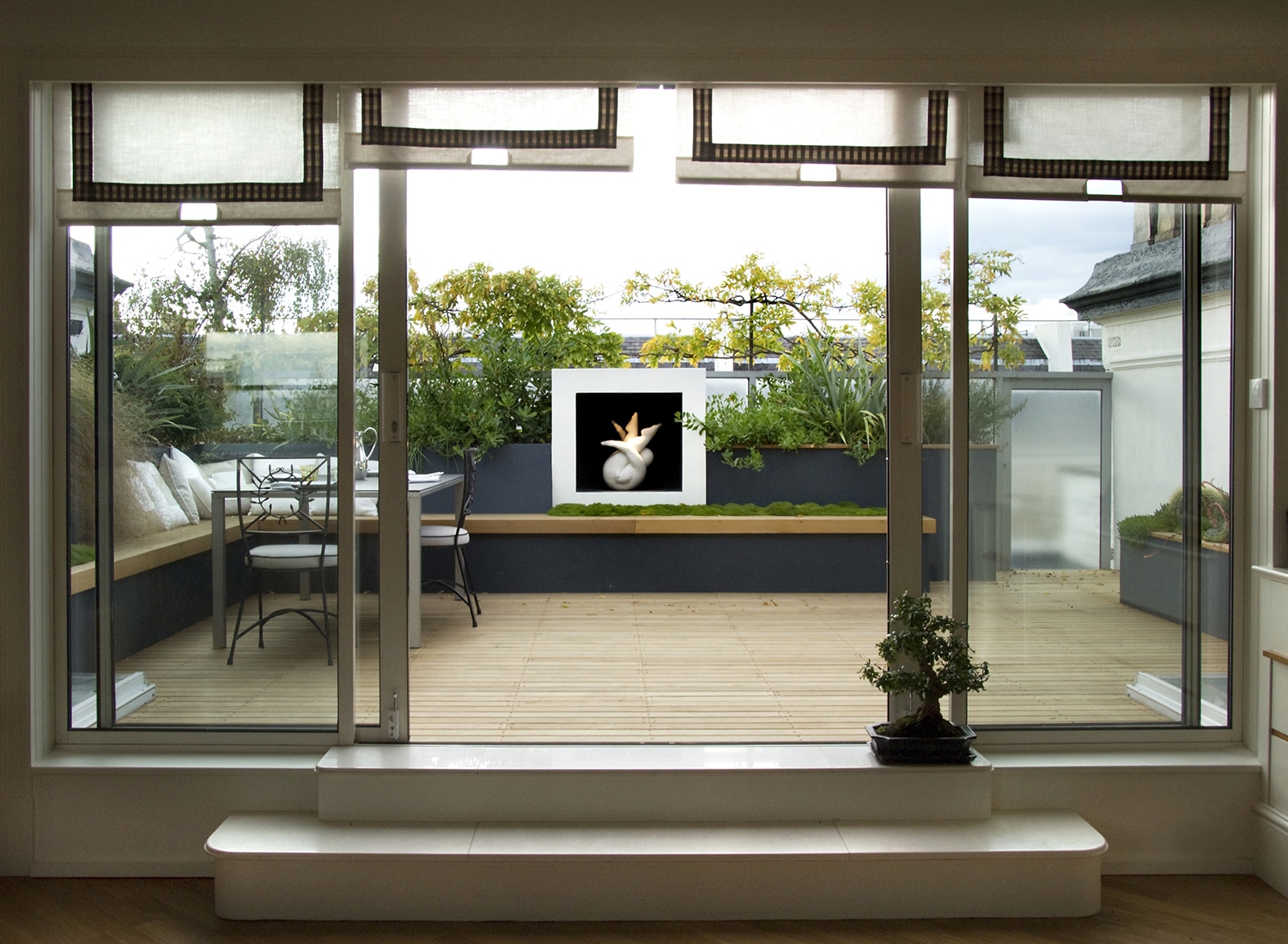 Looking through the sliding doors to the terrace and the sculptural plinth
