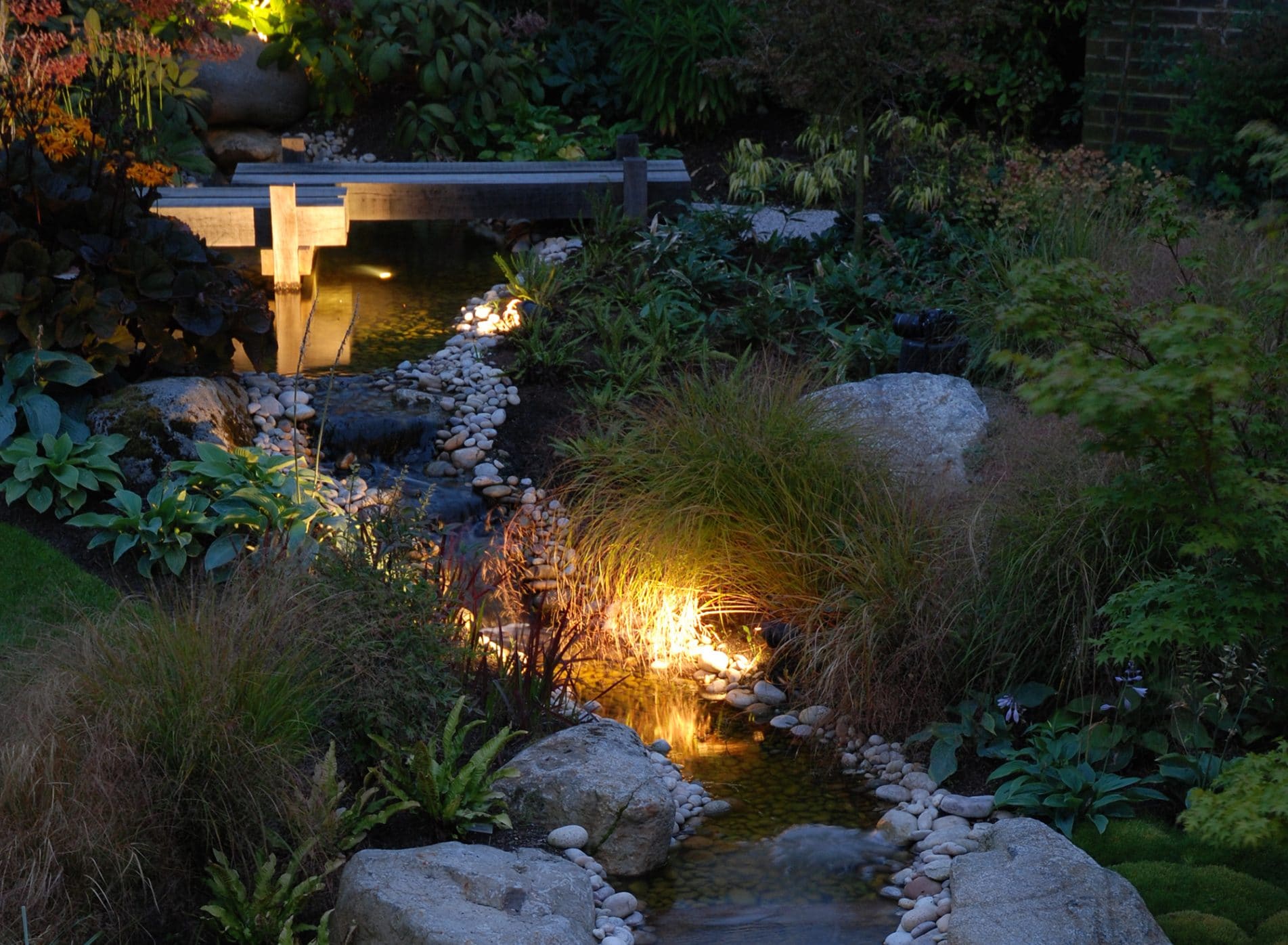 Water feature lit at night - Modern Japanese Garden