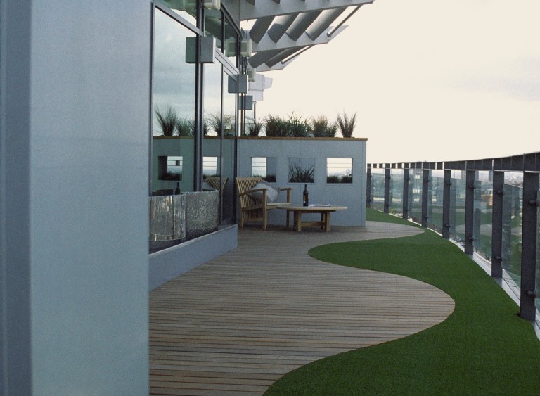 View down the terrace to show the artificial grass and apertures which break up the length of terrace