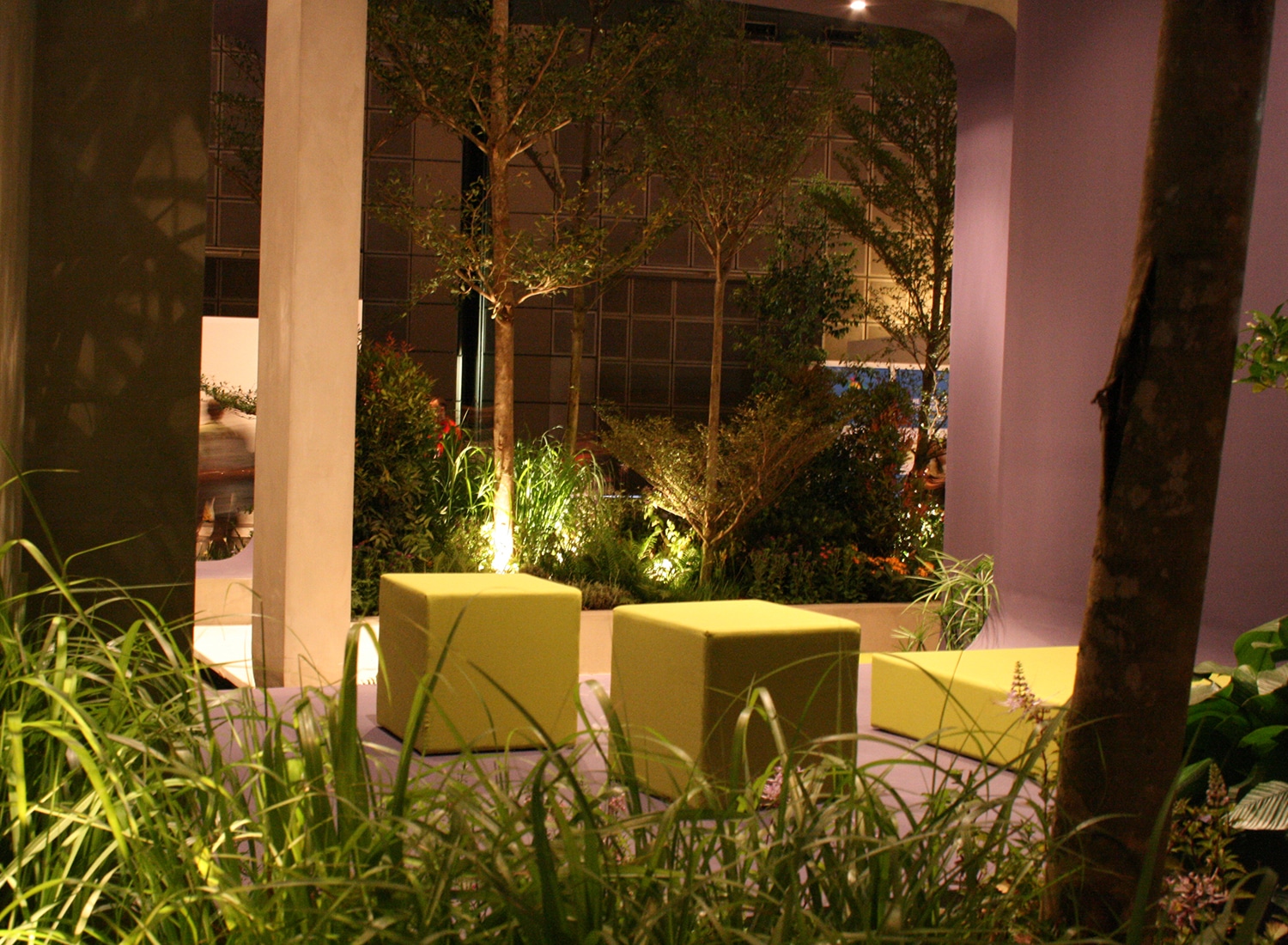 Yellow cube seating within a concrete frame sheltered area