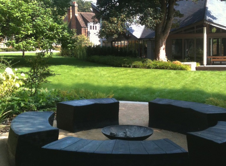 Modern circular seating area with firepit at the Box House