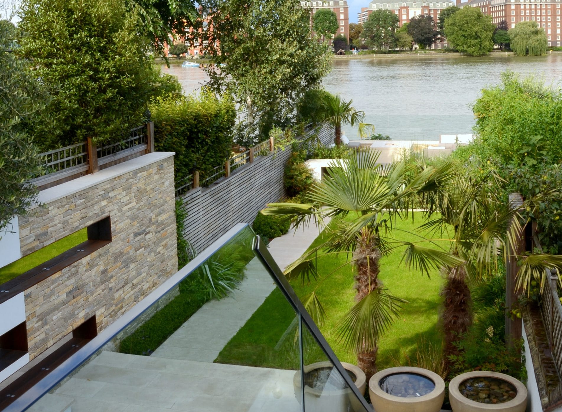 View of sleek sophisticated garden looking down to the river
