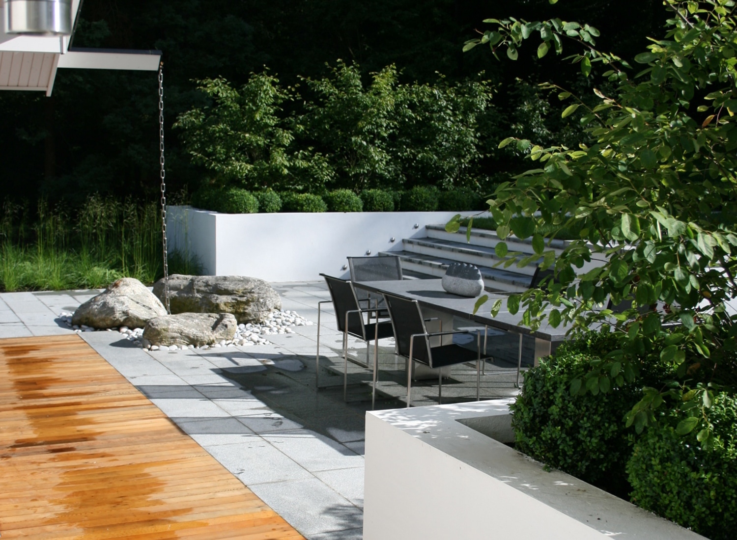 Wooden and concrete patio area with dining table