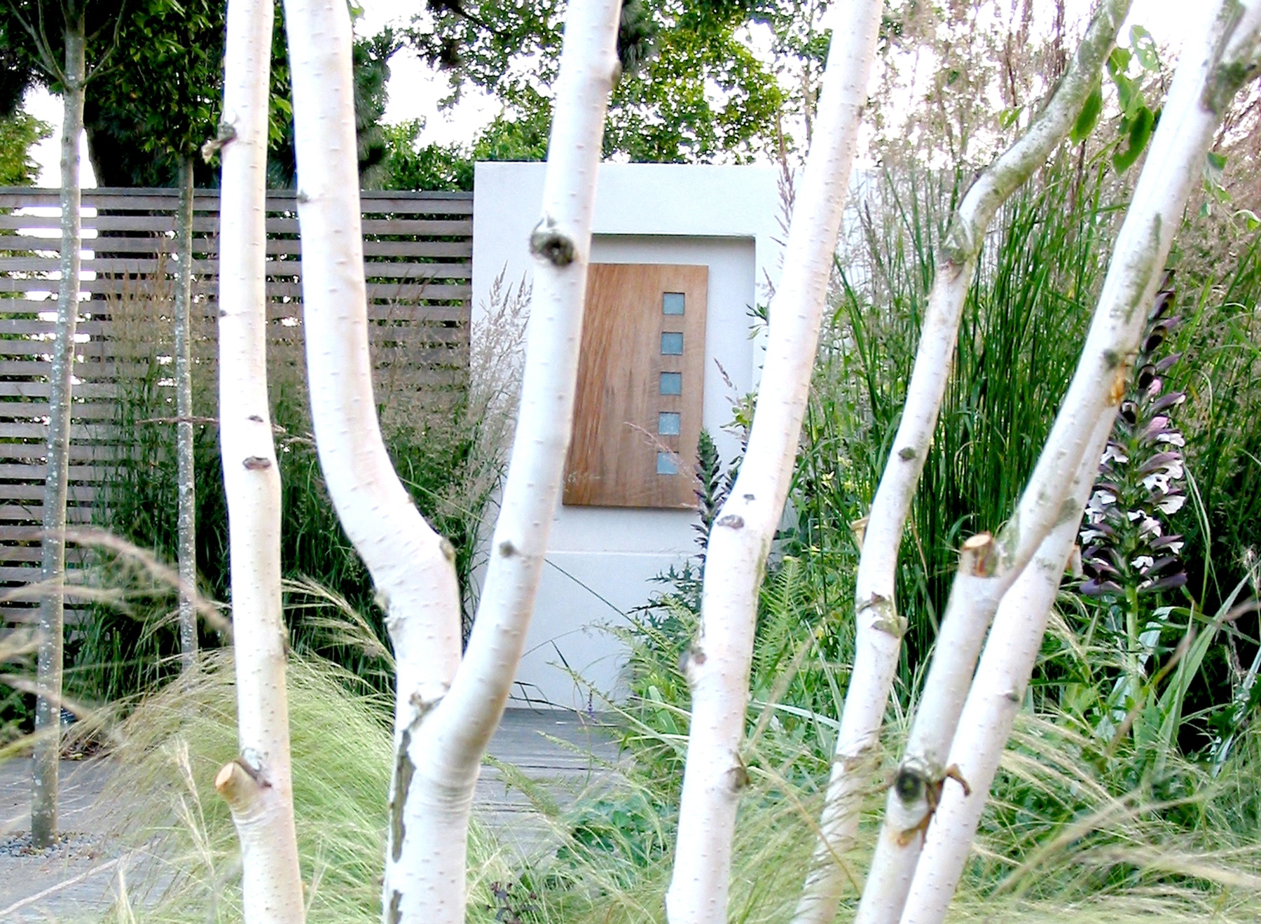 Wall sculpture viewed through tree branches