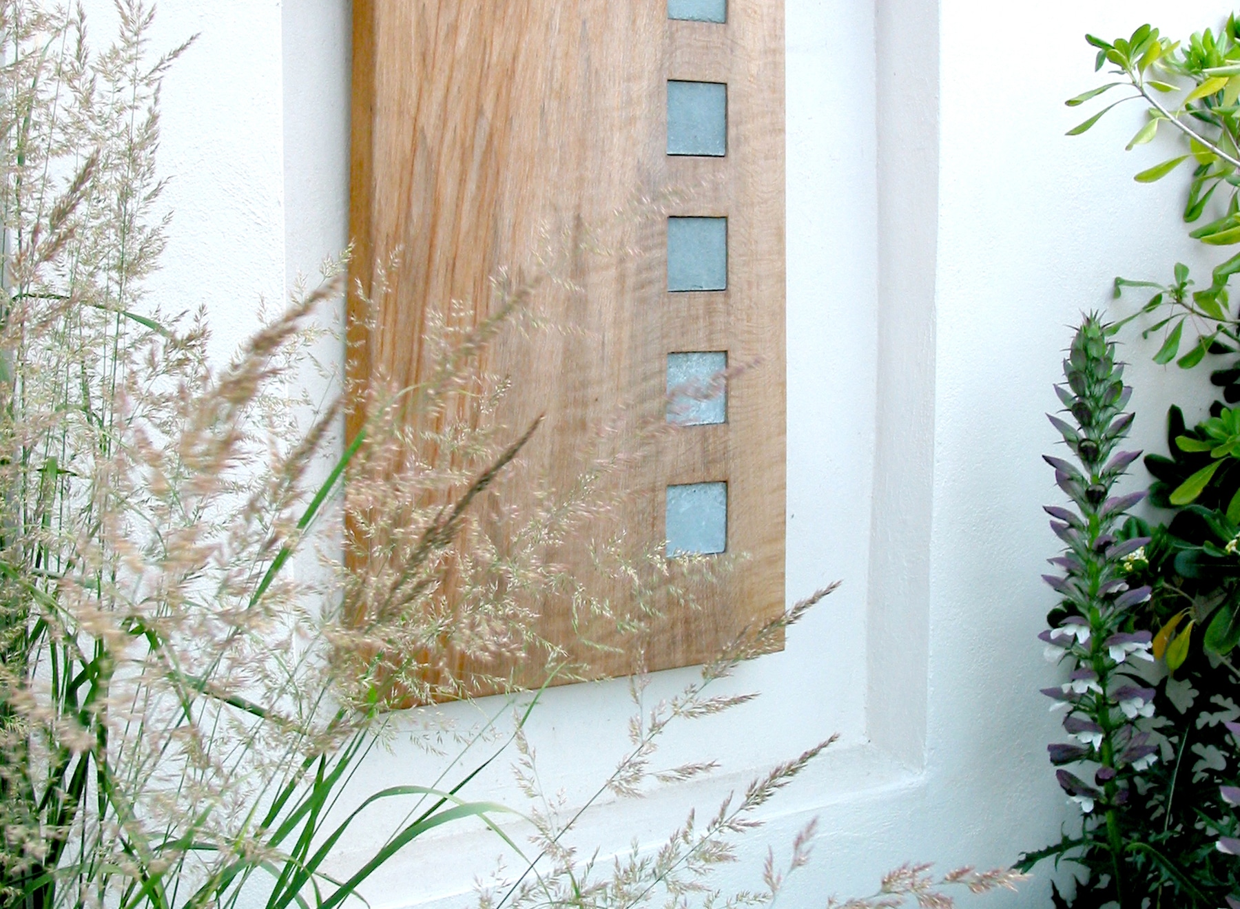 Wall sculpture of a slab of oak with inset limestone tiles