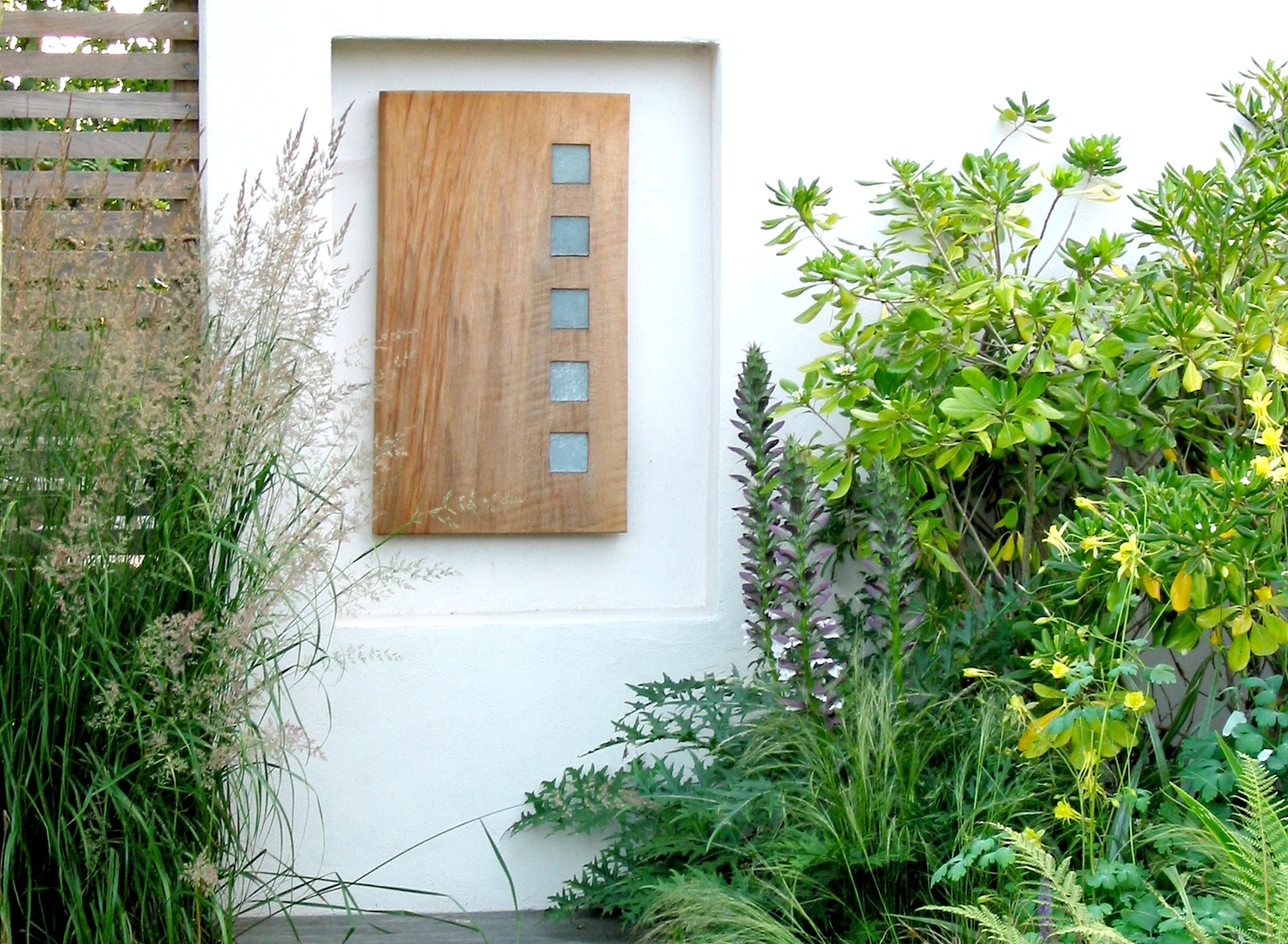 The wall sculpture with shrubs and grasses surrounding