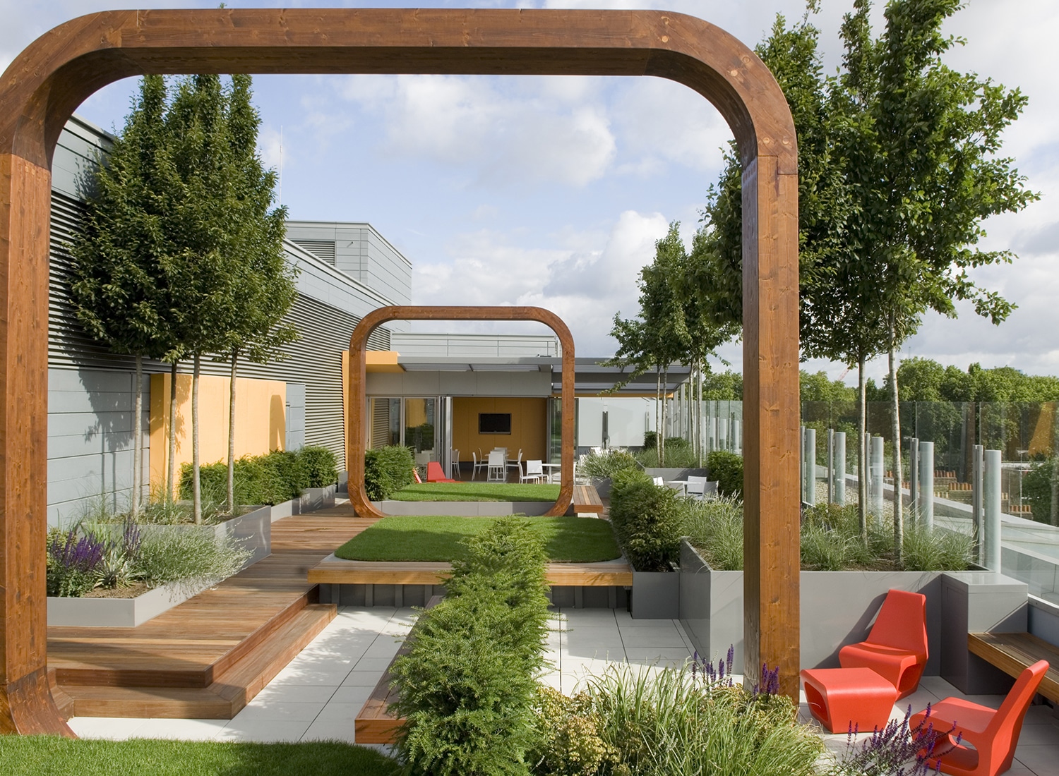 View through the wooden arches towards a seating area