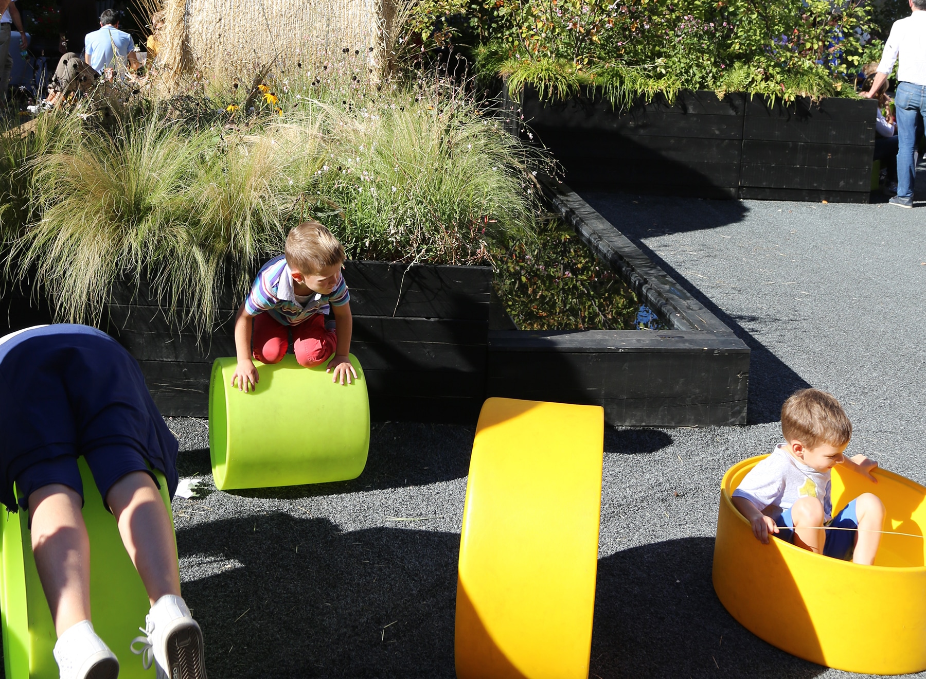 Children play in bright green and yellow tubes