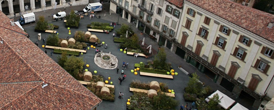 Overhead view of the Piazza Vecchia garden with haybales and benches