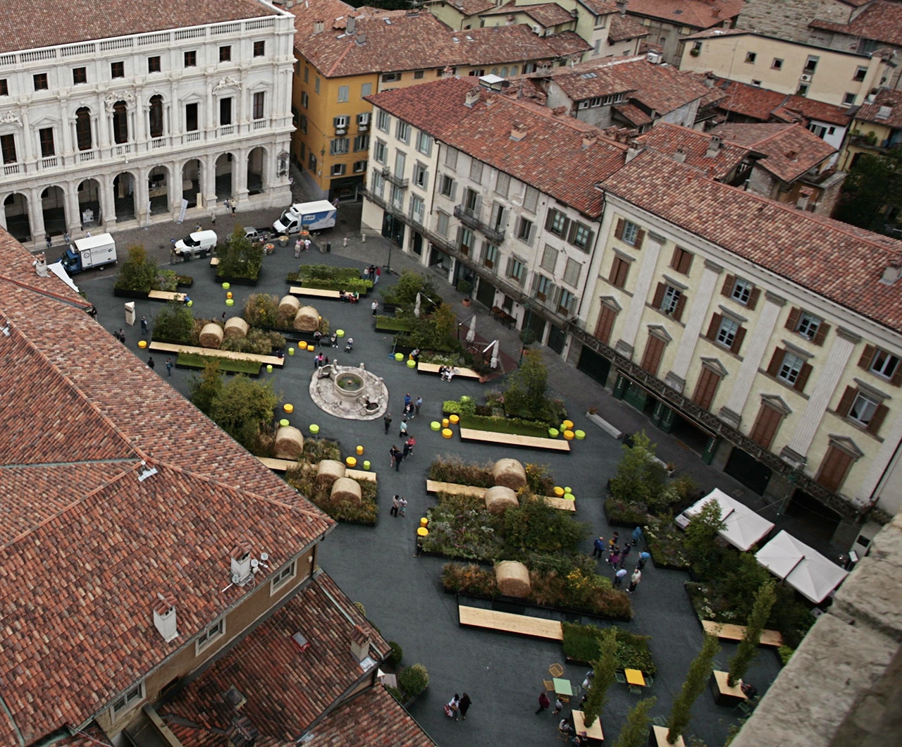 Overhead view of the Piazza Vecchia garden with haybales and benches