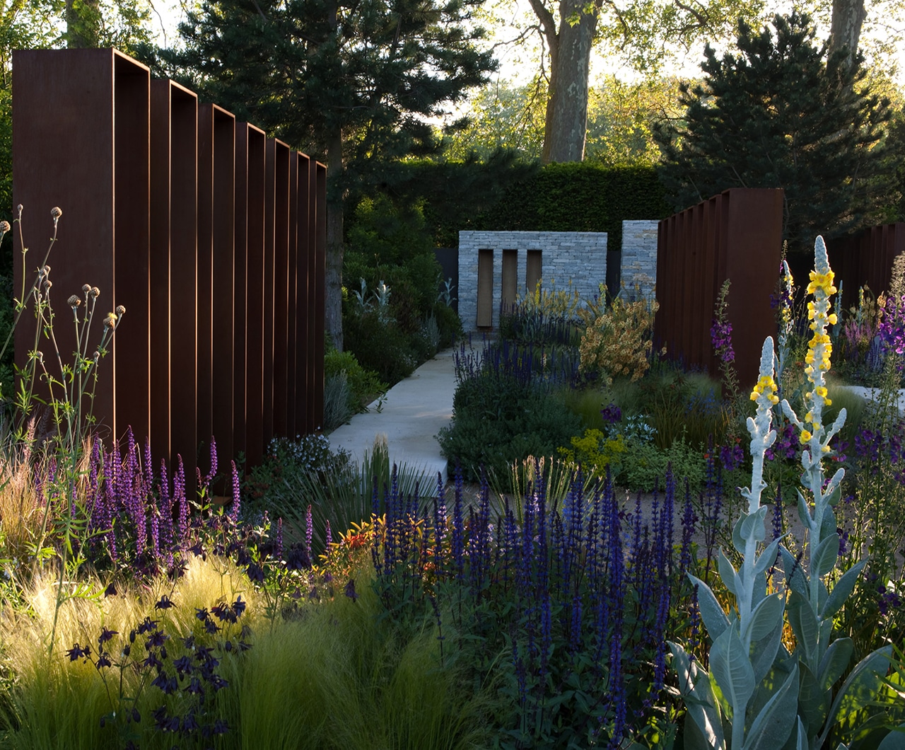 RHS Chelsea Flower Show 2010 view down the path towards the architectural stone wall