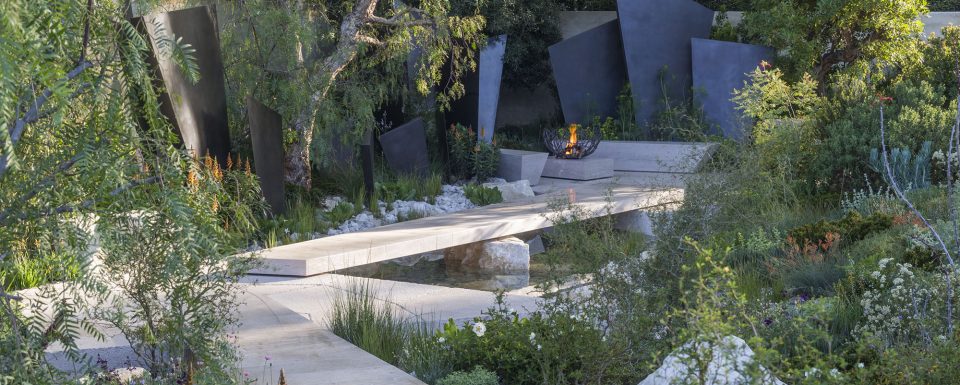 The Telegraph Garden Pathway With Stone Sculptures And Green Shrubs