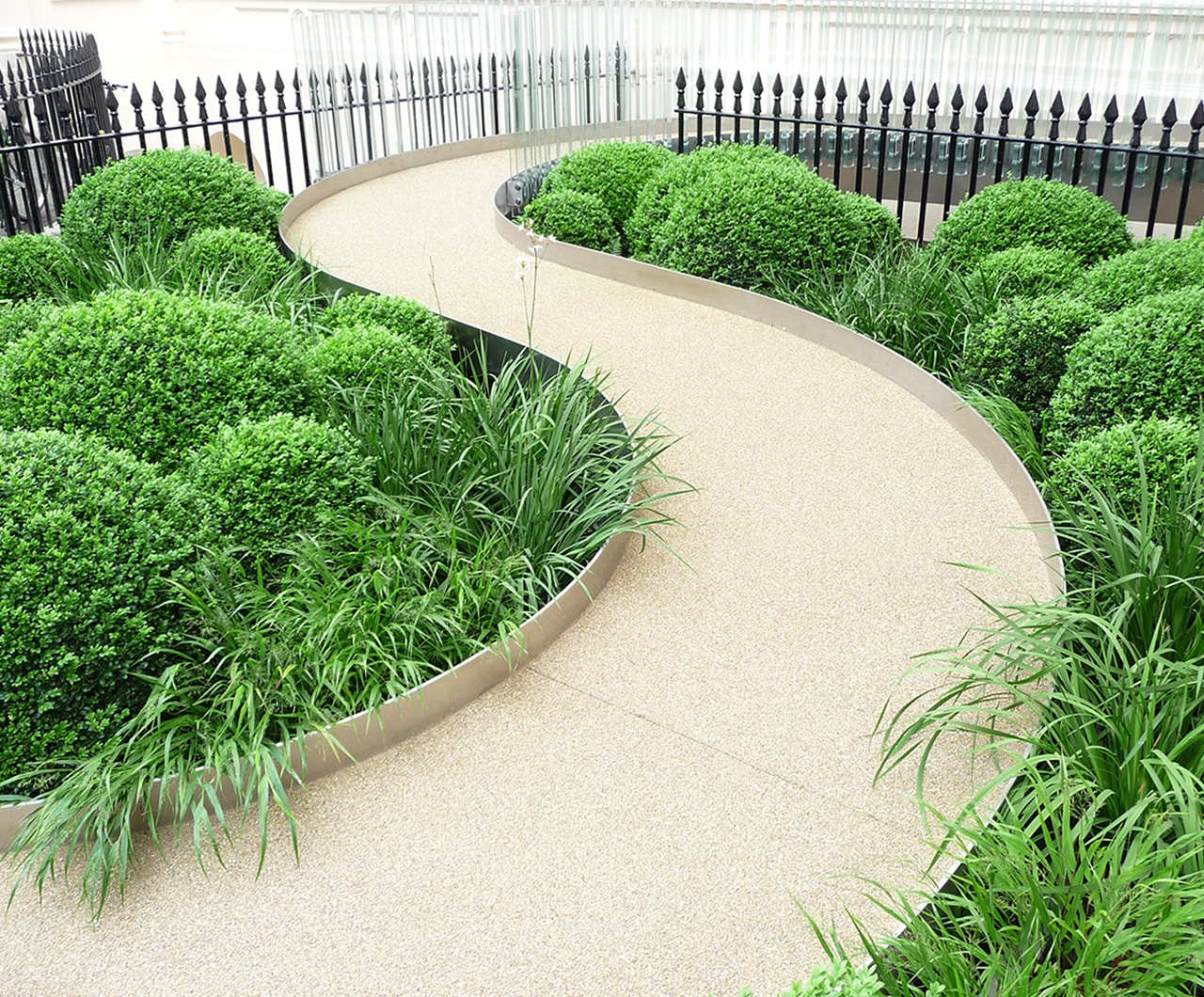 Winding Path With Side Plant Beds Featuring Greenery