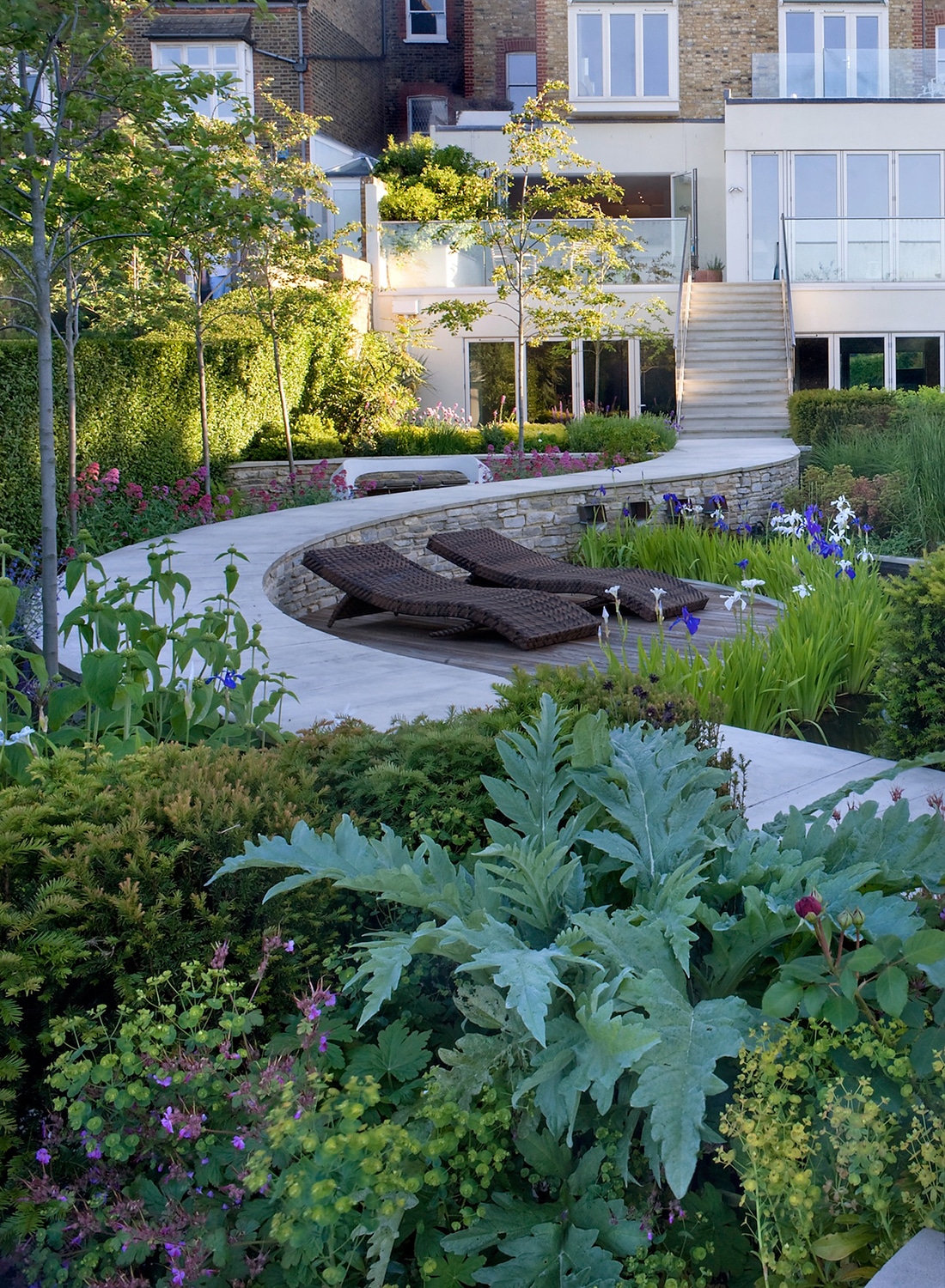 The snaking curved path through the Tributary Garden viewed looking back to the house