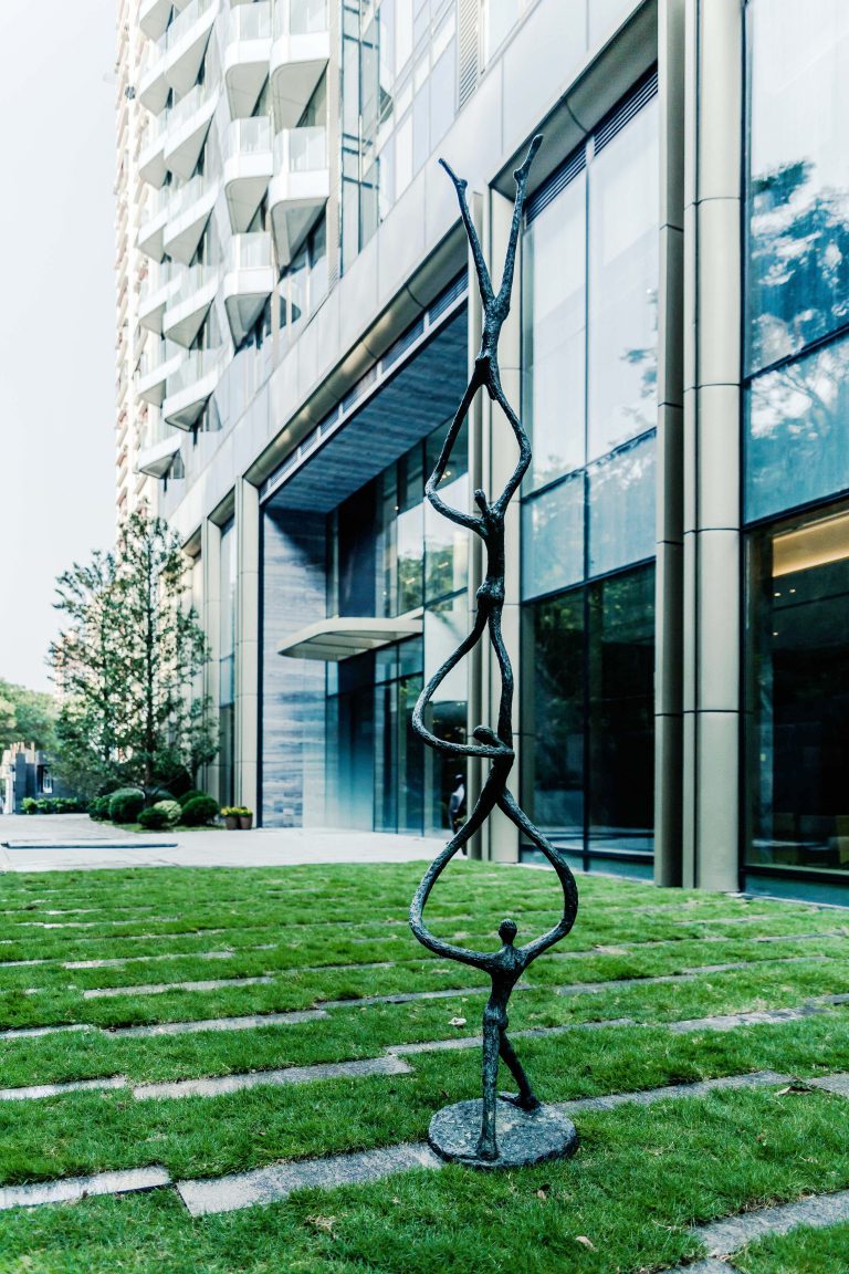 Modern Statue Of Four Figures Outside A Luxury Residential Apartment Block In Hong Kong