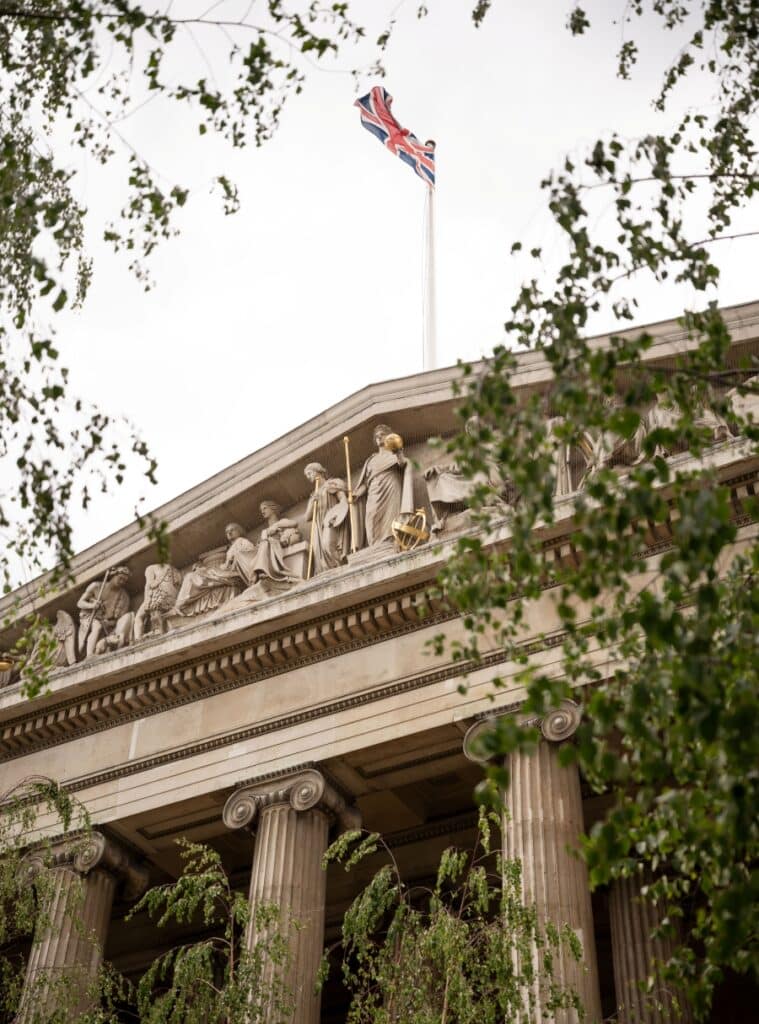 A view of the British Museum through the canopy of birch trees