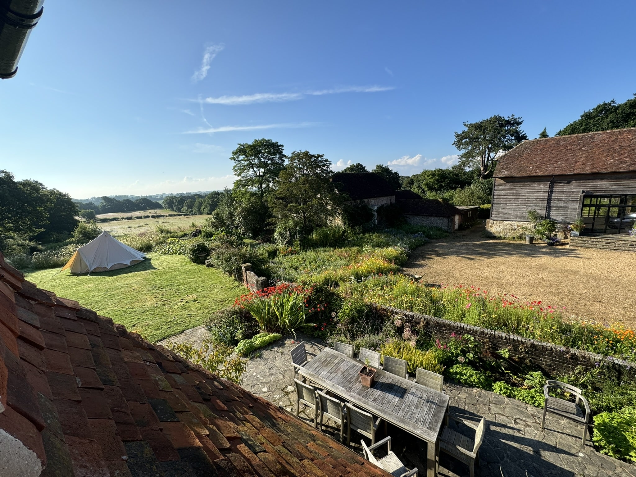 large country garden with flower meadow and dining area